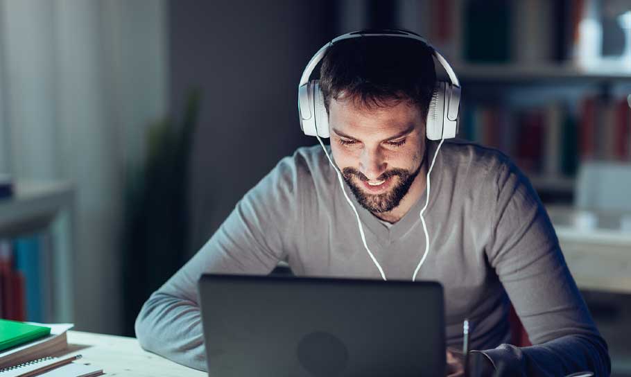 man-using-laptop-and-headphones