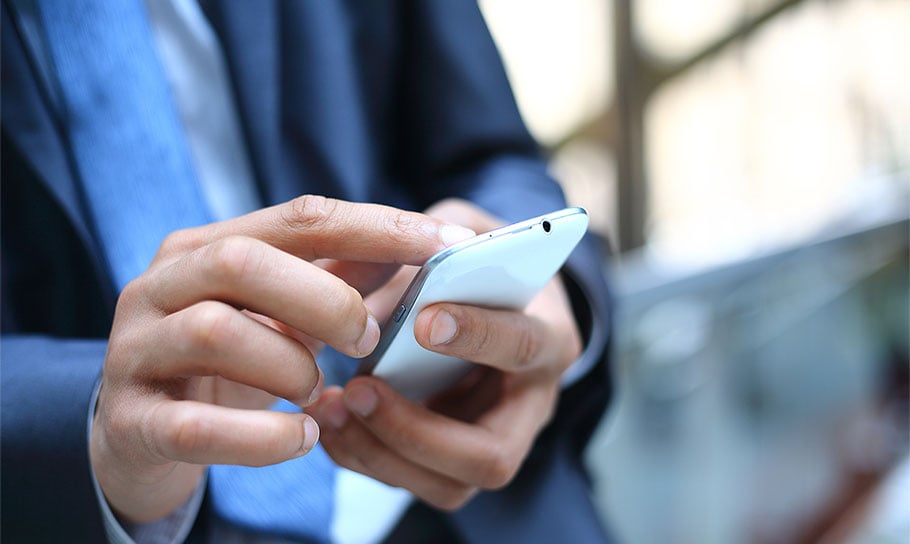 image of a man checking his mobile phone