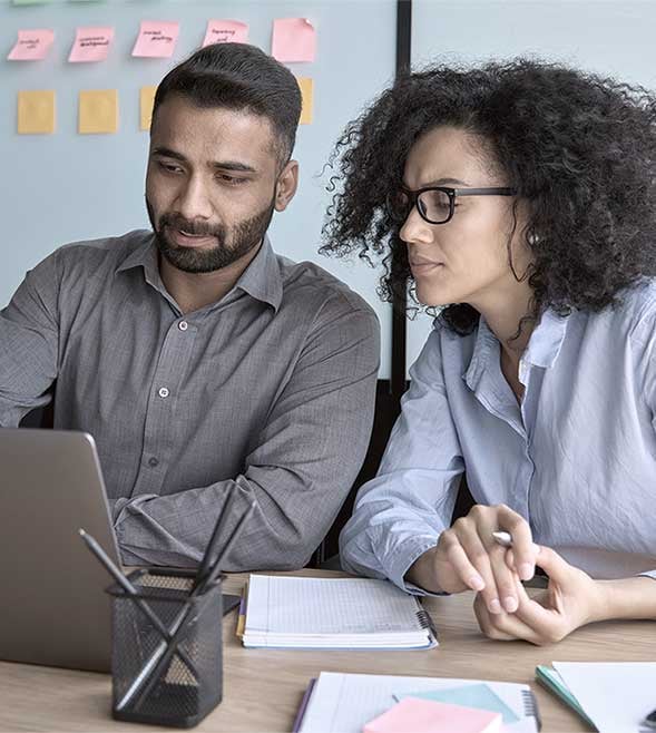 Image of two teammates working