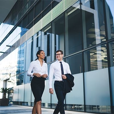 Two colleagues walking together talking