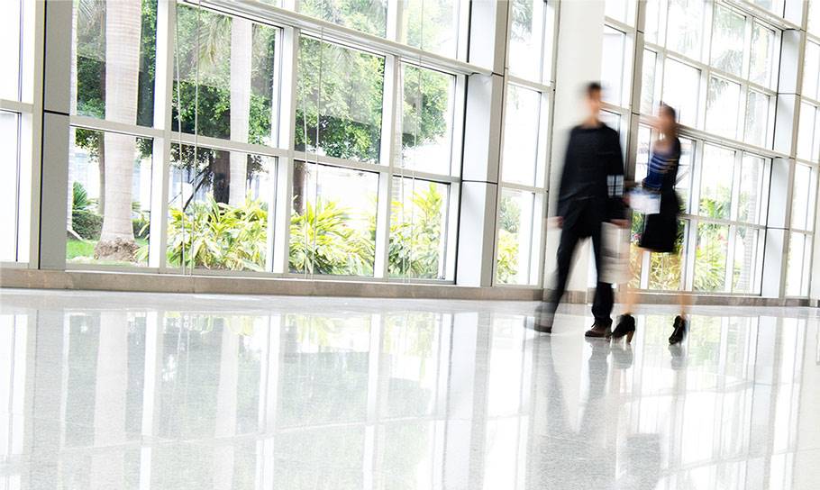 two people walking in office 