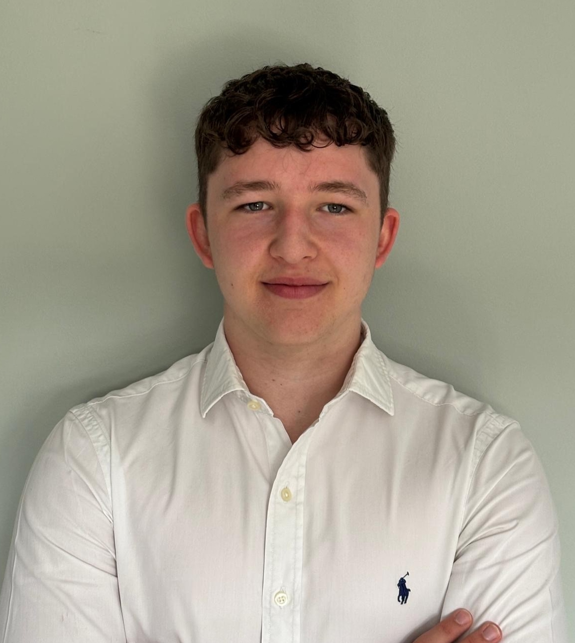 Joe in white shirt, arms folded