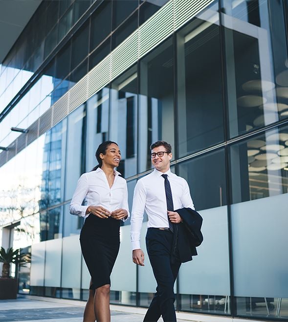 Two colleagues walking together talking