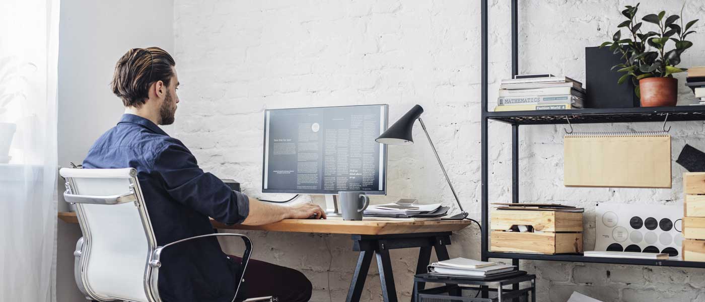 image depicting a man working remotely