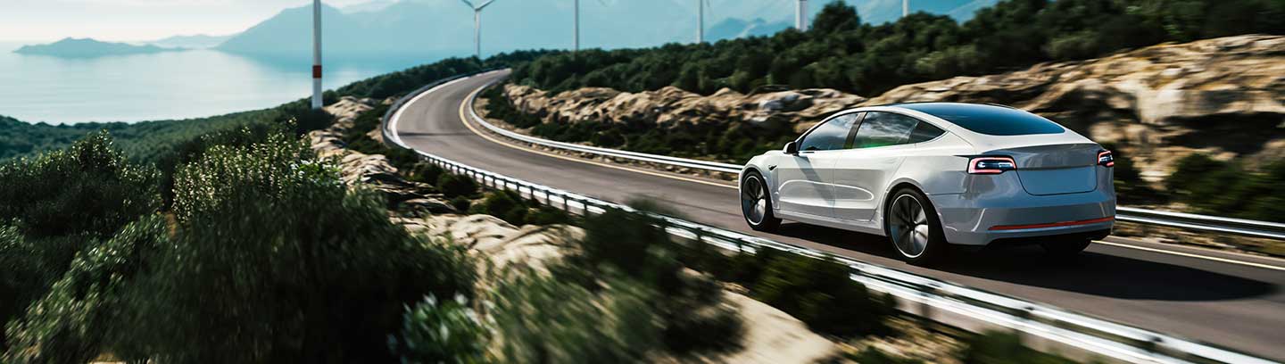 Image depicting a white car driving on an empty street