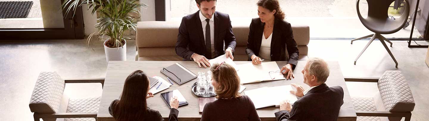 Image depicting a business meeting at a conference table