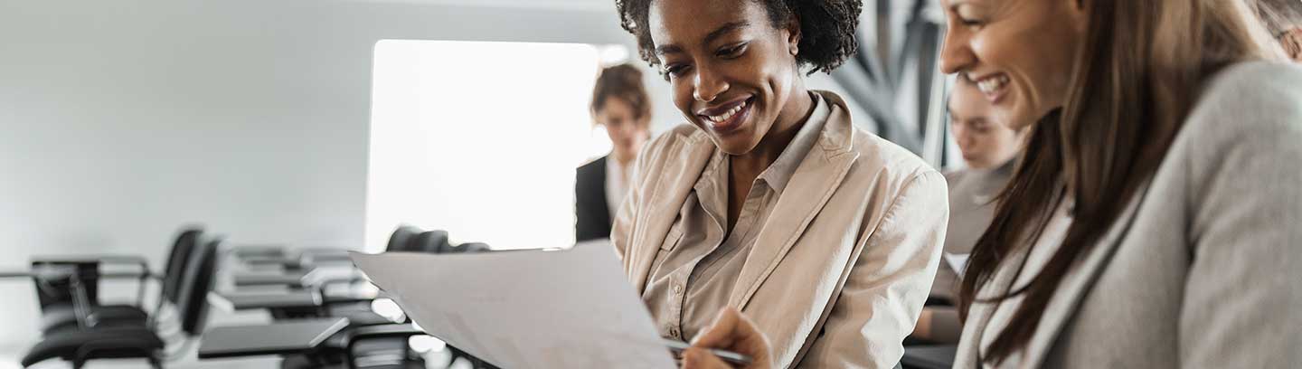 image depicting business women reading a document