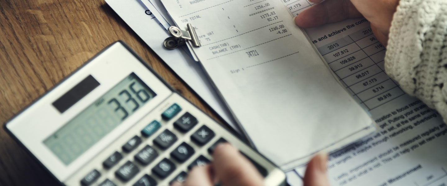 A close up image of a calculator and piece of paper