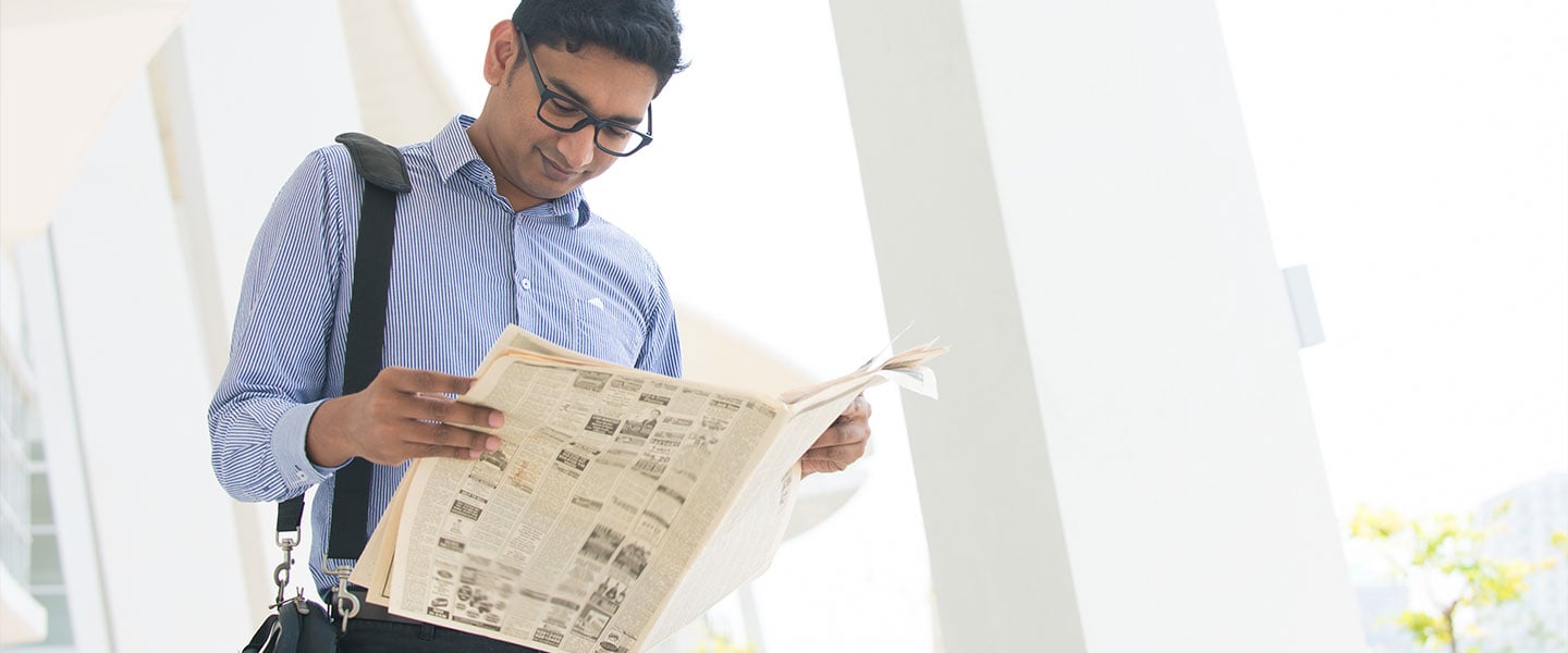 a man reading a newspaper