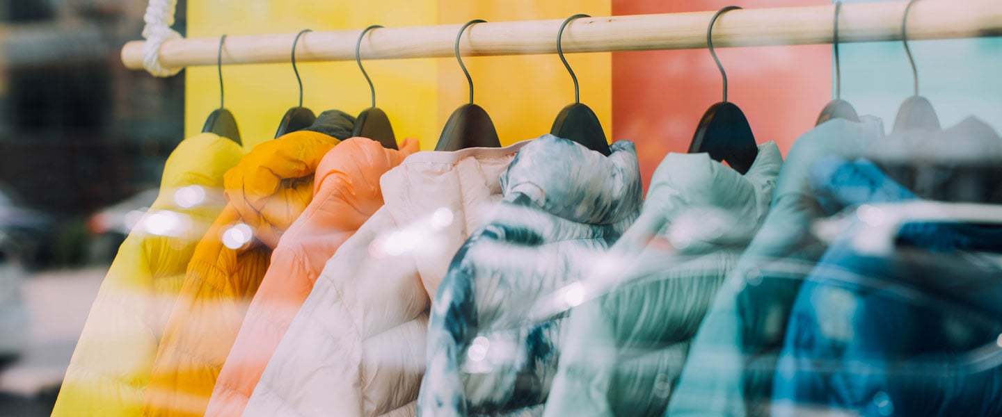 Colourful shirts on a rack inside a retail store