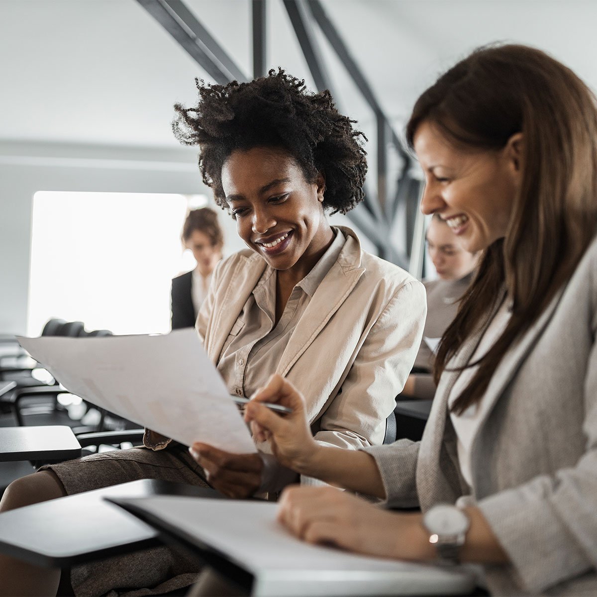 image of two business women reading document 