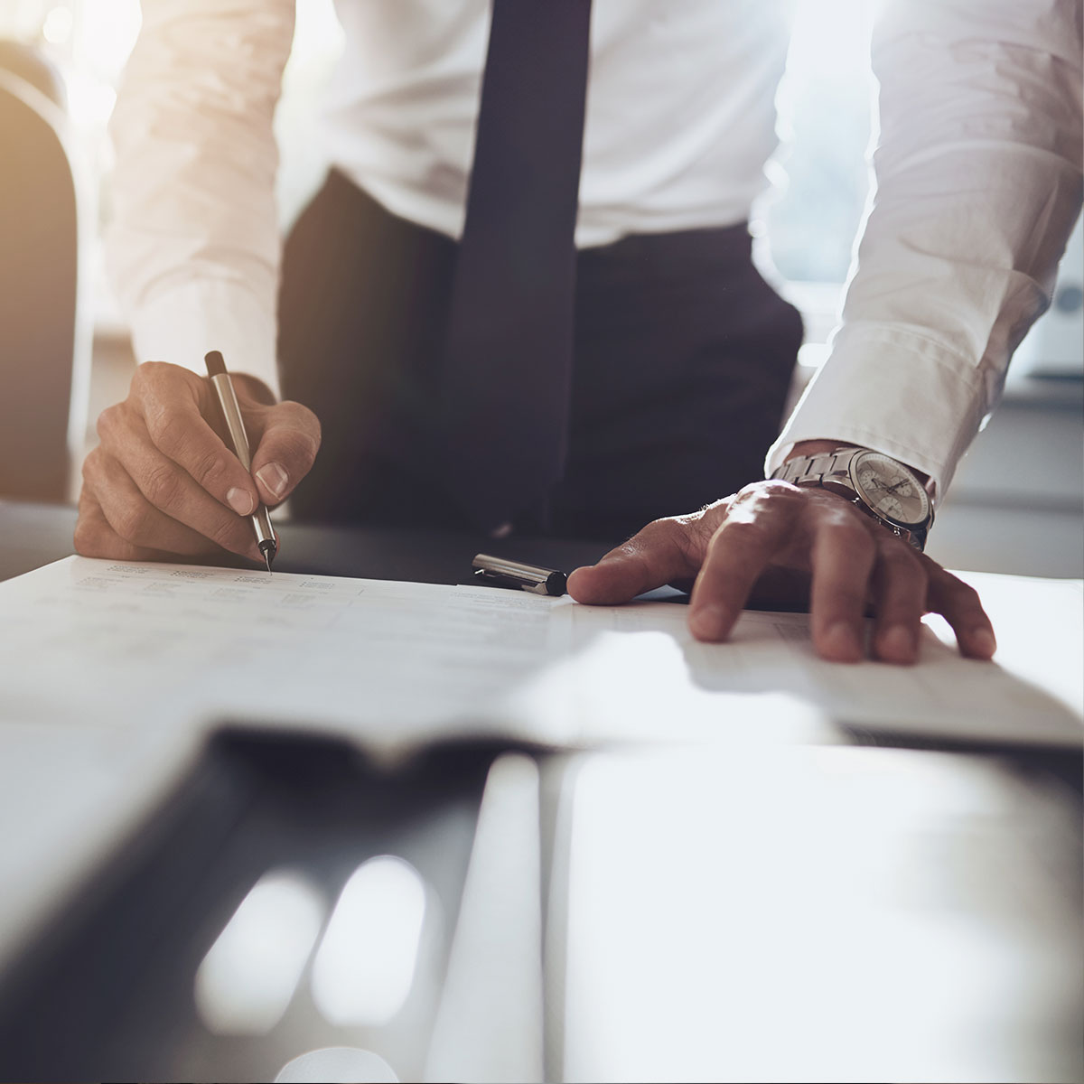 image of a man signing a contract