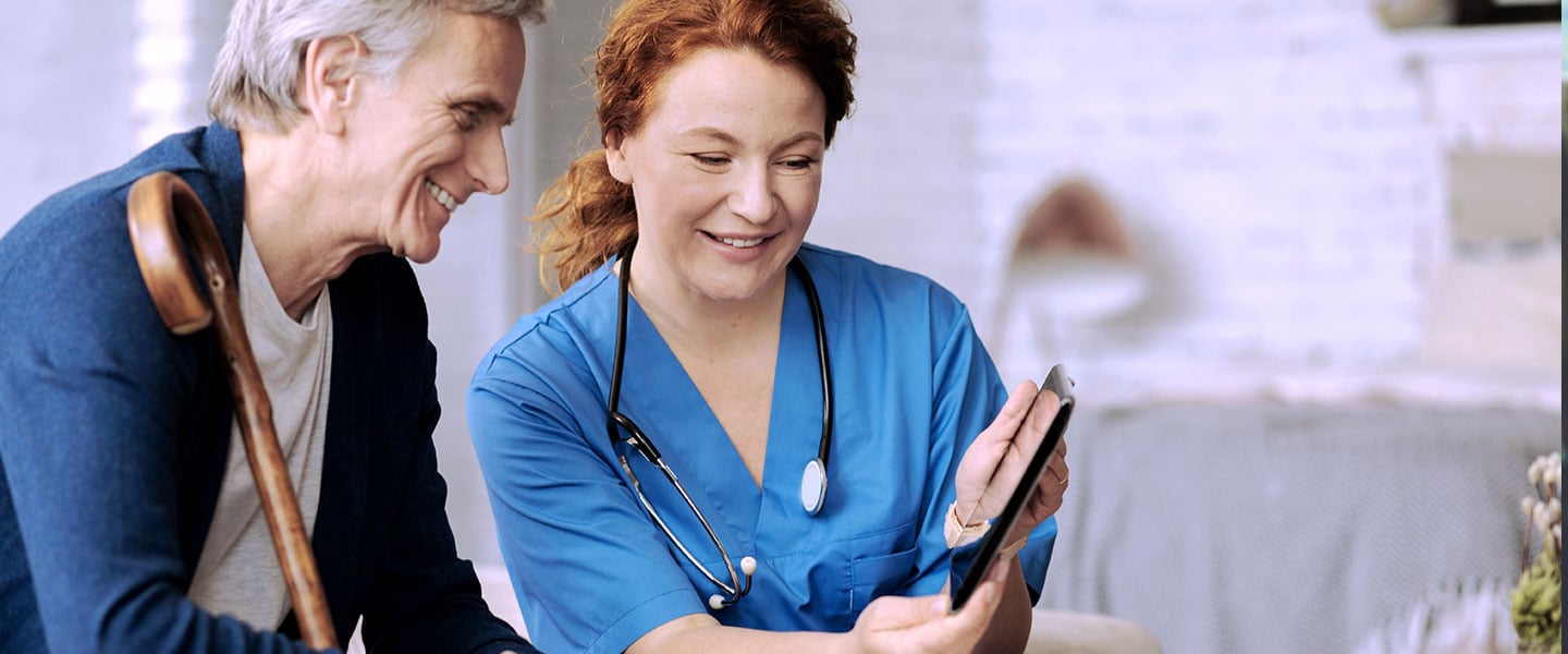 Joyful nurse and patient engaged in conversation