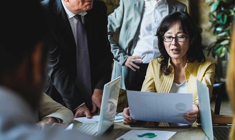 image depicting a woman analysing documents