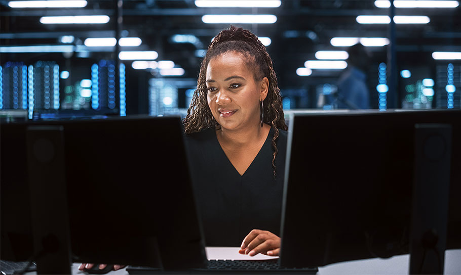 A woman working on a computer in an IT environment