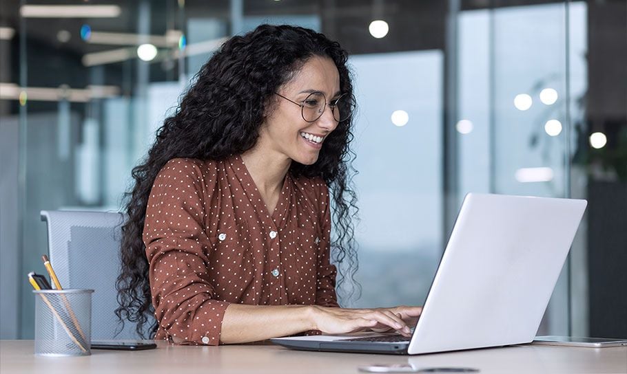 a woman working and smiling