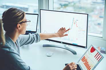 image depicting a woman working on a laptop