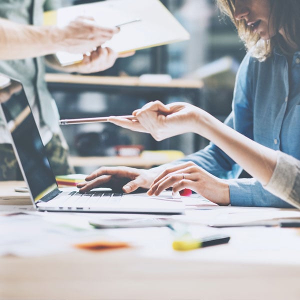 Two people working together at desk