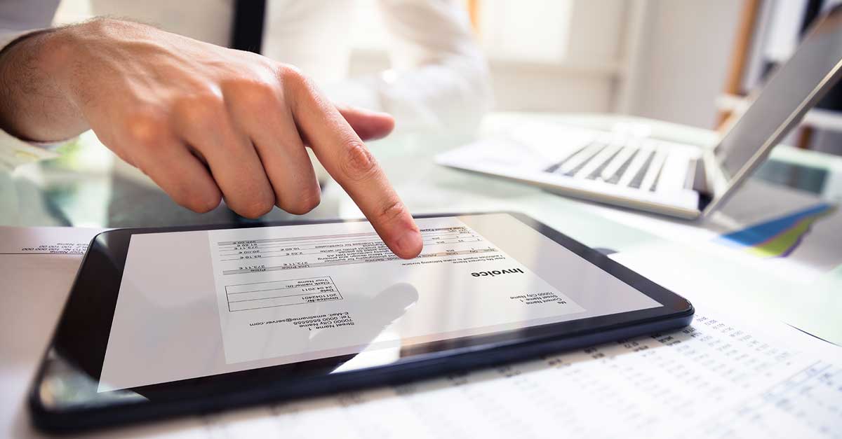 Image for a man opening a financial document on a tablet